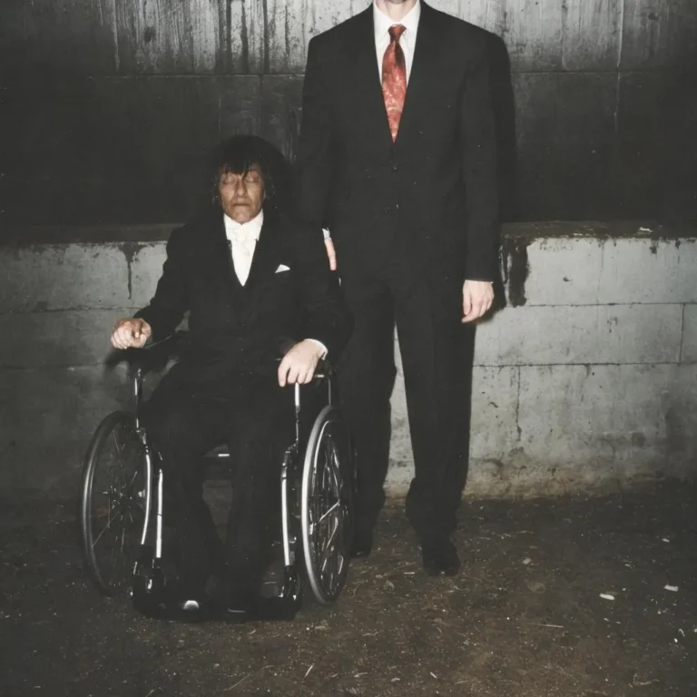 A detailed image of a man in a wheelchair wearing formal attire with another man standing next to him. Emphasize that this is an AI generated image using stable diffusion.