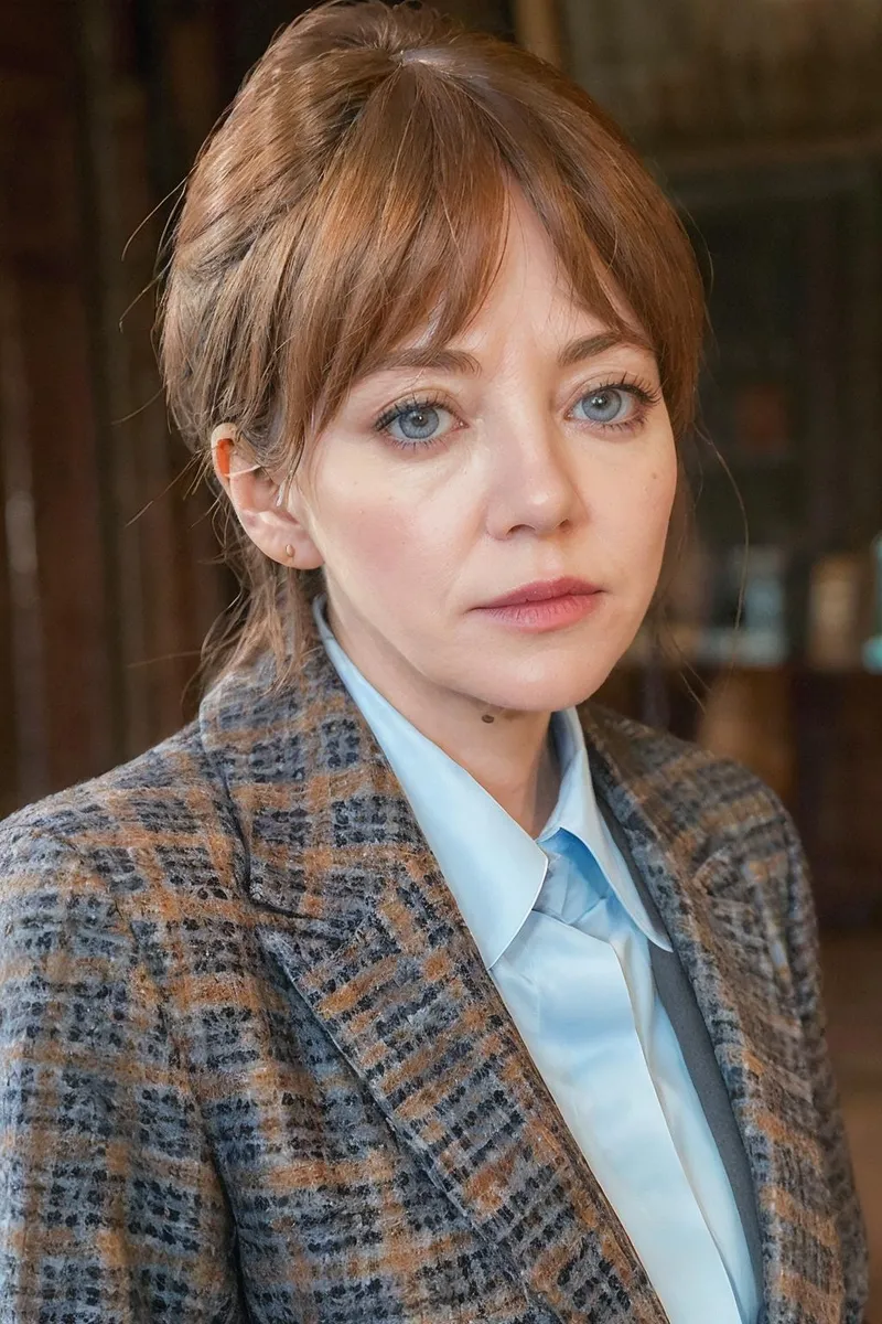 A detailed AI-generated image of a woman with light brown hair, fair skin, and blue eyes, wearing a plaid suit and a light blue blouse, created using Stable Diffusion.