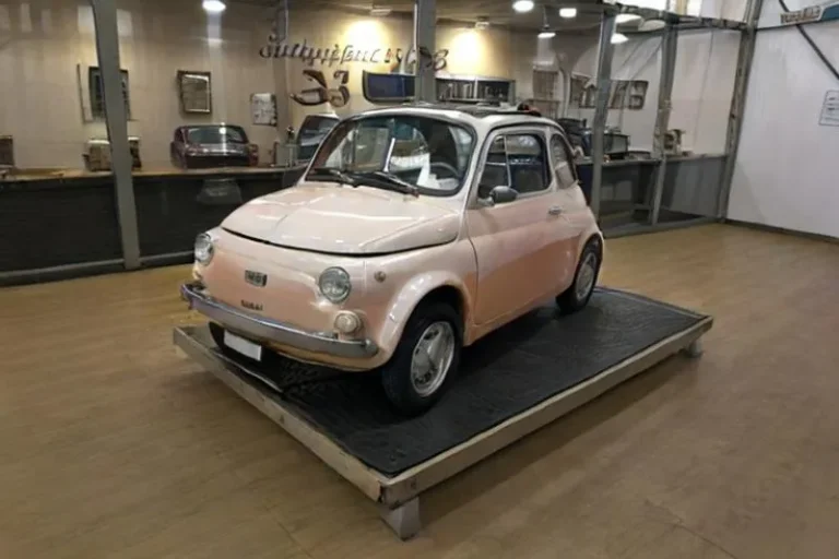 A vintage Fiat 500 displayed in a showroom, emphasizing the retro and classic design. This is an AI generated image using stable diffusion.