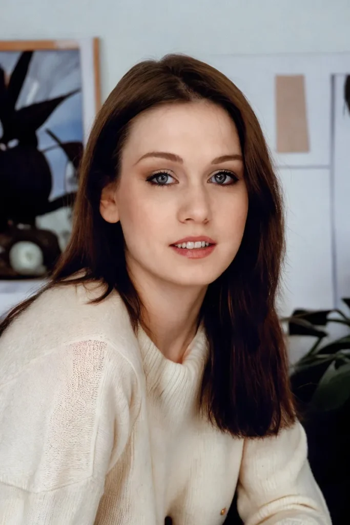 A woman with brown hair, wearing a cream-colored knit sweater, is looking at the camera with a gentle expression. The scene is lit with natural light in an indoor setting. Ai generated image using stable diffusion.